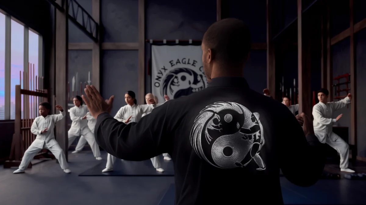 Onyx Eagle Claw identity applied to a black martial arts training jacket in a studio.